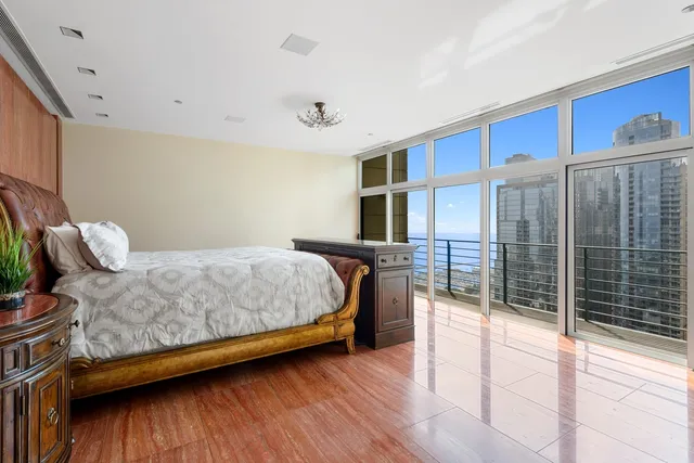 a bathroom with a granite countertop sink a mirror and shower