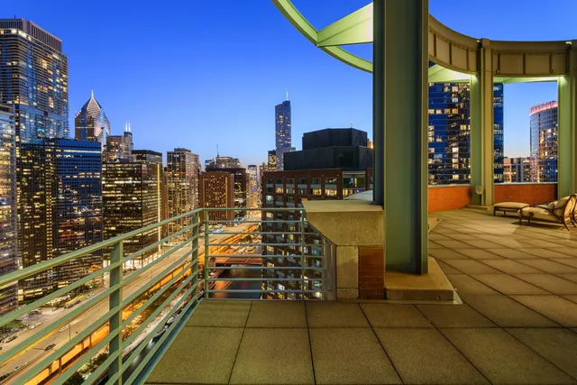 a balcony with furniture and a potted plant