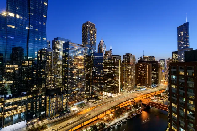 a view of swimming pool outdoor seating and city view