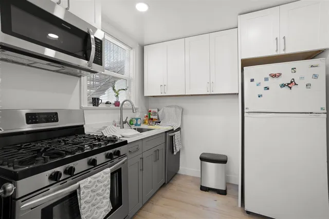 a kitchen with a stove and a refrigerator