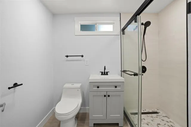 a bathroom with a toilet and a shower