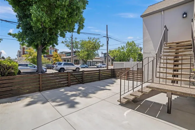 a view of a chairs and table in the back yard of the house