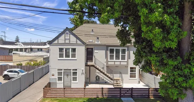 a front view of a house with a garden