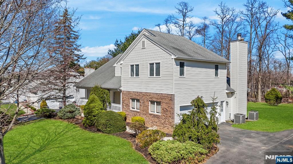 34 Knob Hill Road Morganville, NJ 07751 - Photo 1 of 50 a front view of a house with a yard