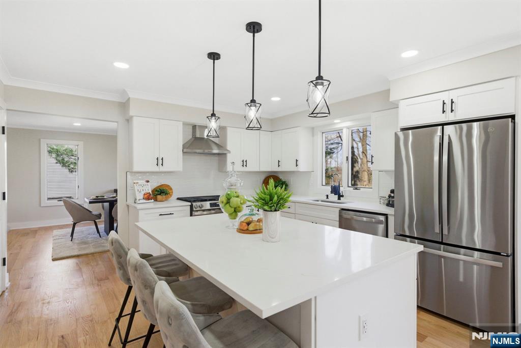 34 Knob Hill Road Morganville, NJ 07751 - Photo 17 of 50 a kitchen with stainless steel appliances sink refrigerator dining table and chairs
