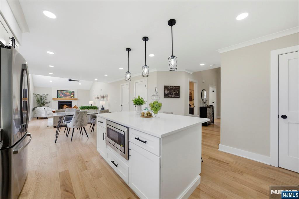 34 Knob Hill Road Morganville, NJ 07751 - Photo 19 of 50 a kitchen with white cabinets and stainless steel appliances