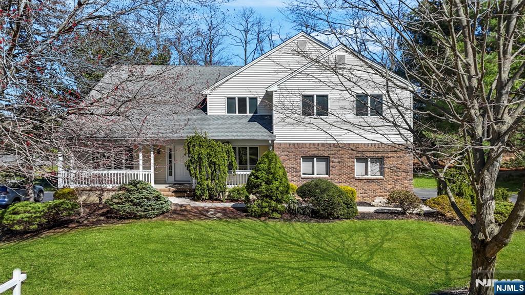 34 Knob Hill Road Morganville, NJ 07751 - Photo 2 of 50 a front view of a house with a garden