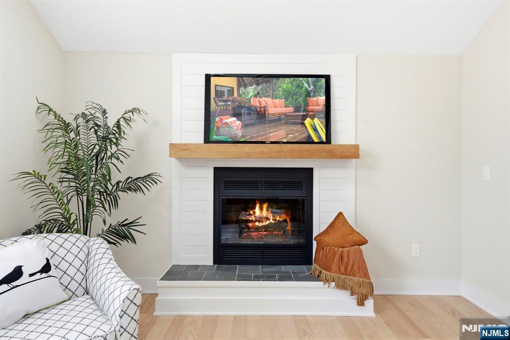 34 Knob Hill Road Morganville, NJ 07751 - Photo 25 of 50 a living room with furniture and a fireplace