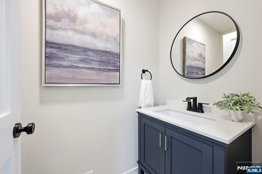 34 Knob Hill Road Morganville, NJ 07751 - Photo 28 of 50 a bathroom with a sink and a mirror