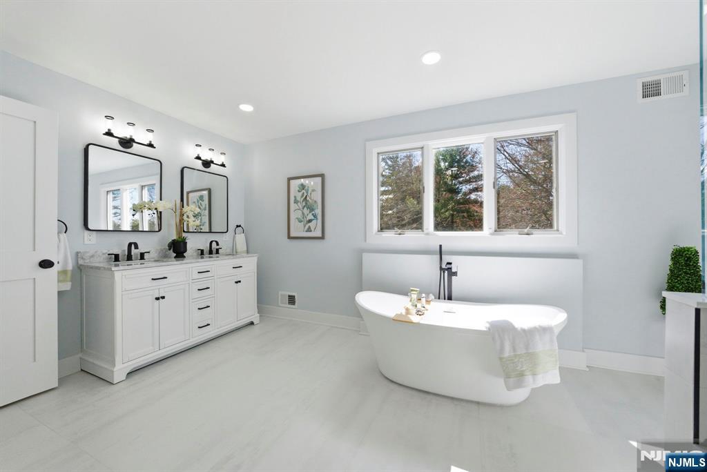 34 Knob Hill Road Morganville, NJ 07751 - Photo 38 of 50 a spacious bathroom with a double vanity sink mirror and bathtub