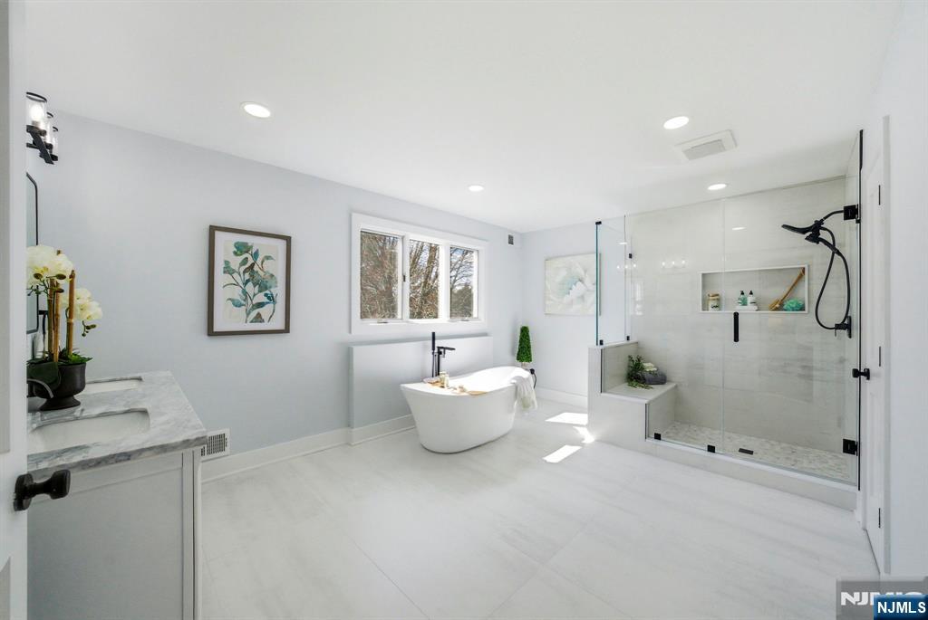 34 Knob Hill Road Morganville, NJ 07751 - Photo 39 of 50 a spacious bathroom with a shower sink and mirror