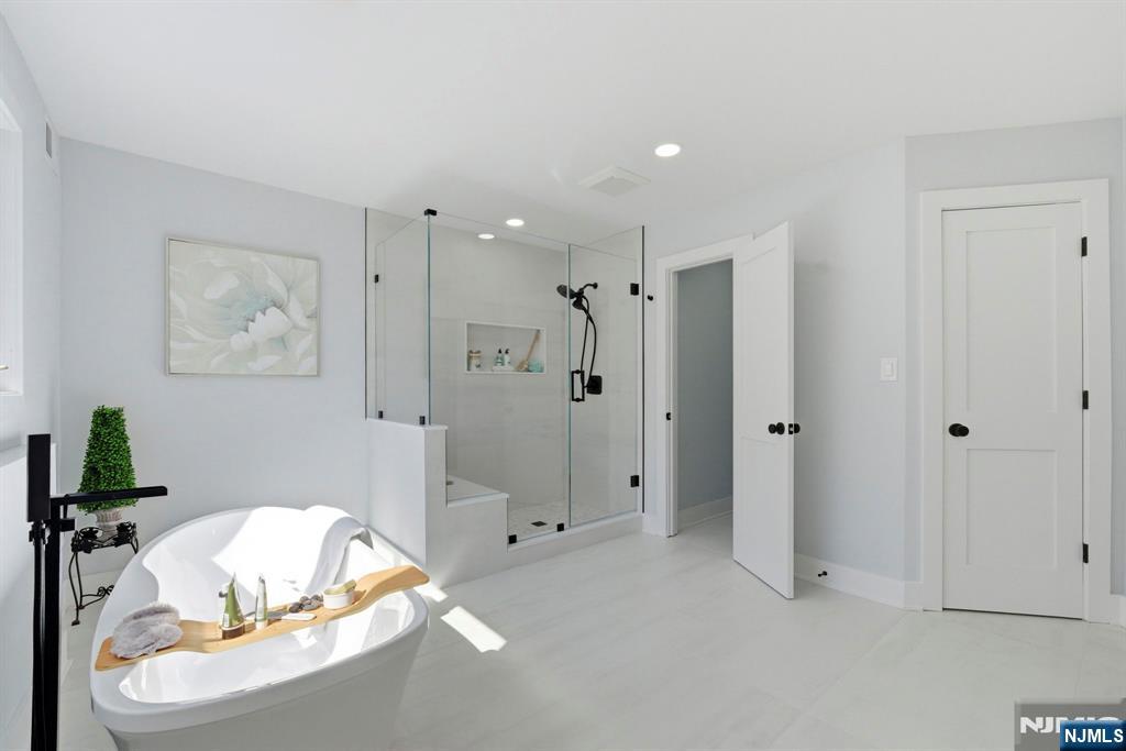 34 Knob Hill Road Morganville, NJ 07751 - Photo 40 of 50 a view of a bathroom with a tub shower and mirror
