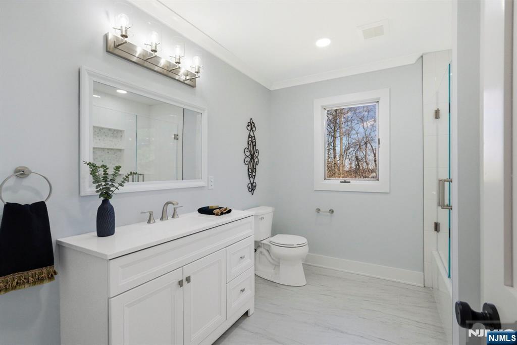 34 Knob Hill Road Morganville, NJ 07751 - Photo 44 of 50 a bathroom with a toilet sink and mirror