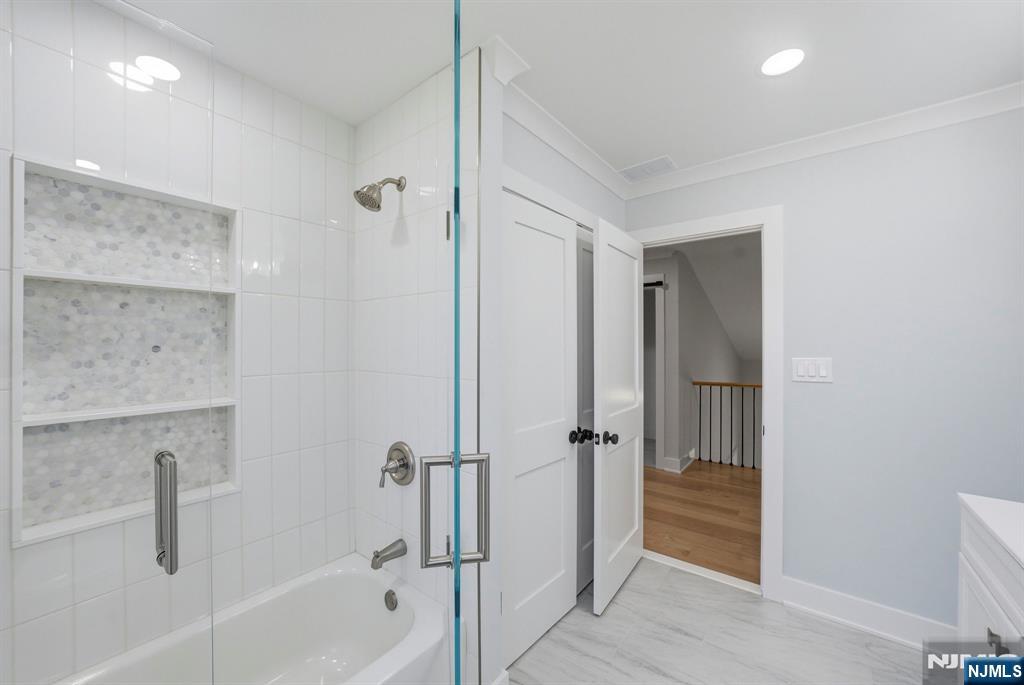 34 Knob Hill Road Morganville, NJ 07751 - Photo 45 of 50 a bathroom with a bathtub and a shower