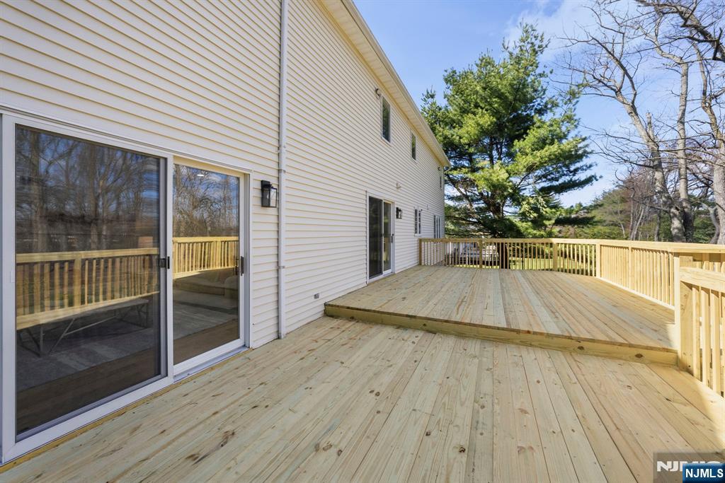 34 Knob Hill Road Morganville, NJ 07751 - Photo 49 of 50 a view of a balcony with floor to ceiling windows and wooden floor
