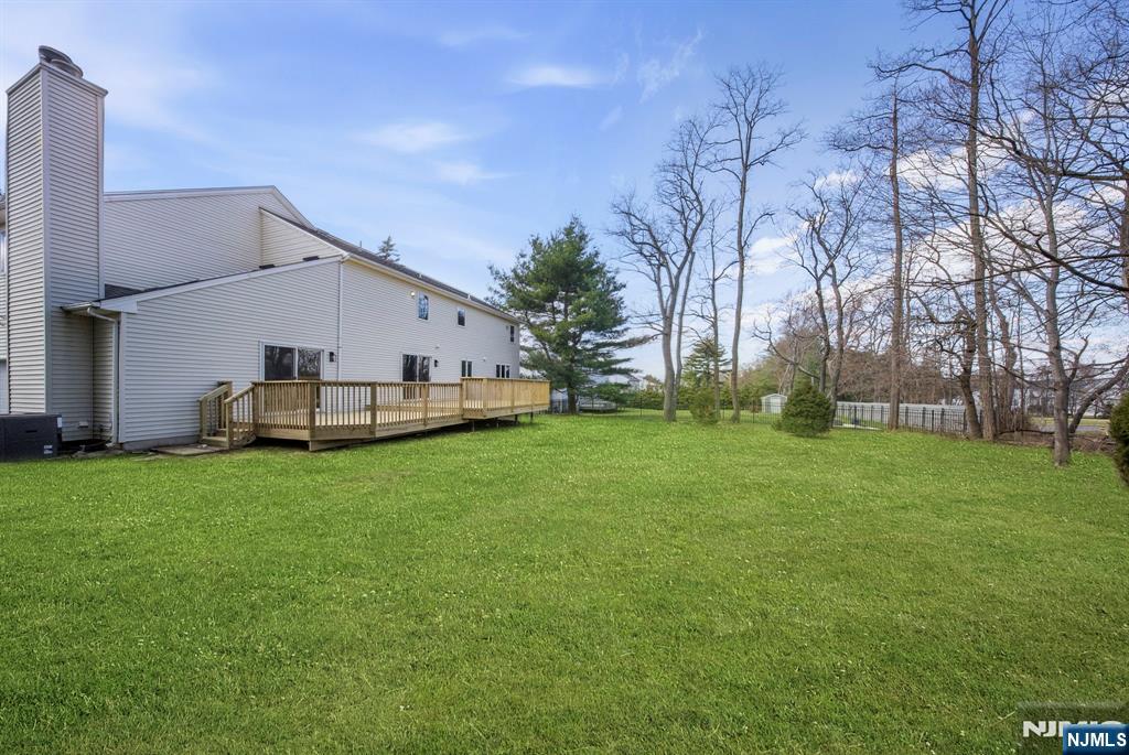 34 Knob Hill Road Morganville, NJ 07751 - Photo 50 of 50 a white house with a big yard and large trees
