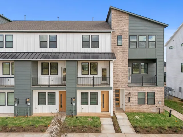a view of a brick house with large windows
