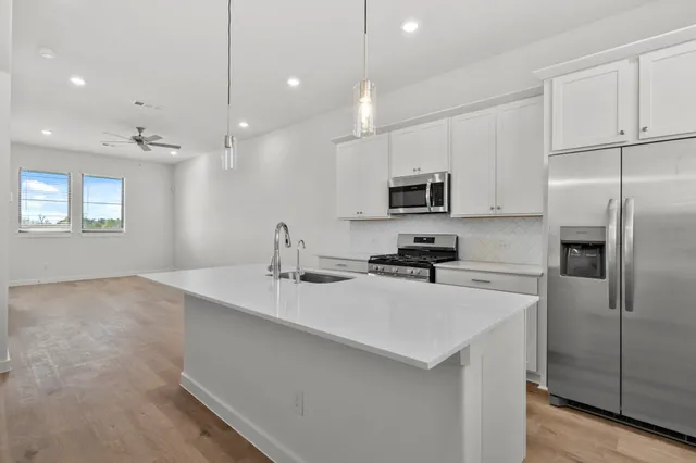 a kitchen that has a sink and a stove