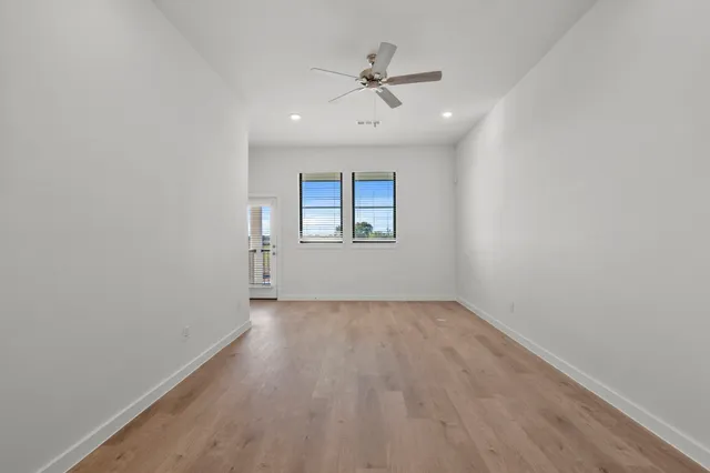 a view of a kitchen with a sink and a refrigerator