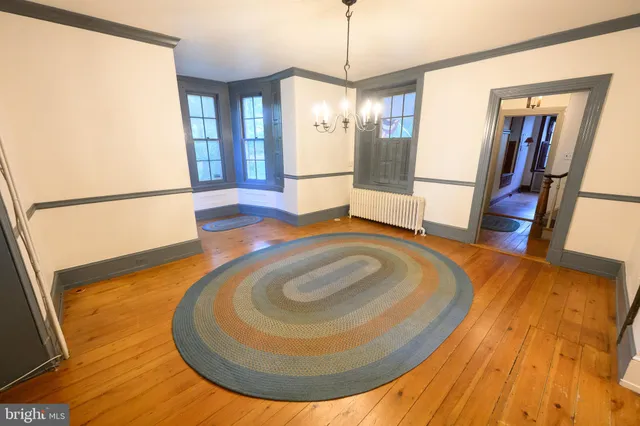 a kitchen with sink a refrigerator and white cabinets