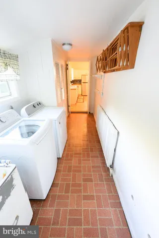 a bathroom with a sink a mirror a toilet and a picture