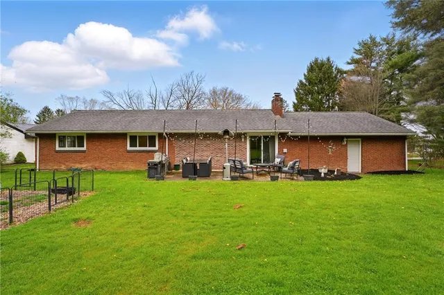 a view of a house with a yard porch and sitting area