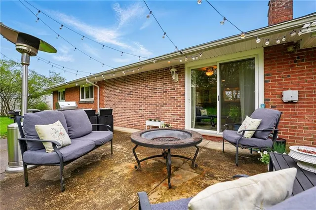 a outdoor living space with furniture and a fireplace