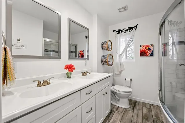 a bathroom with a sink toilet and shower