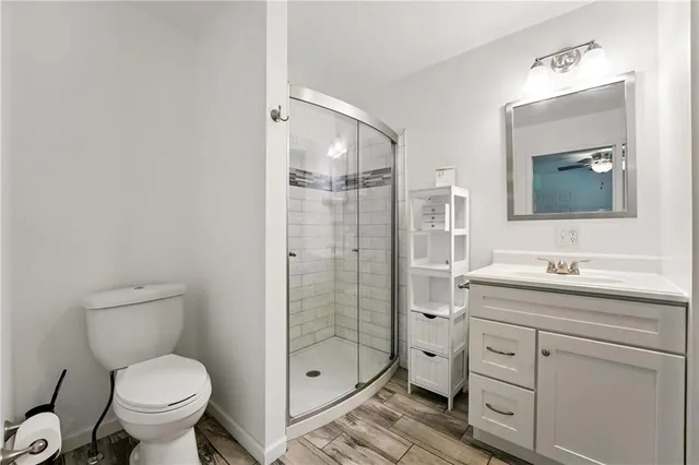 a bathroom with a toilet sink shower and mirror