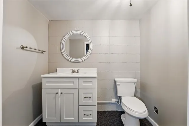 a bathroom with a toilet a sink and a mirror