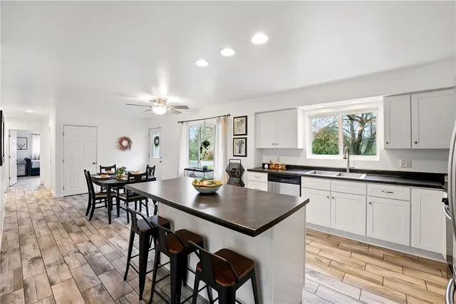 a kitchen with a table chairs stove and cabinets