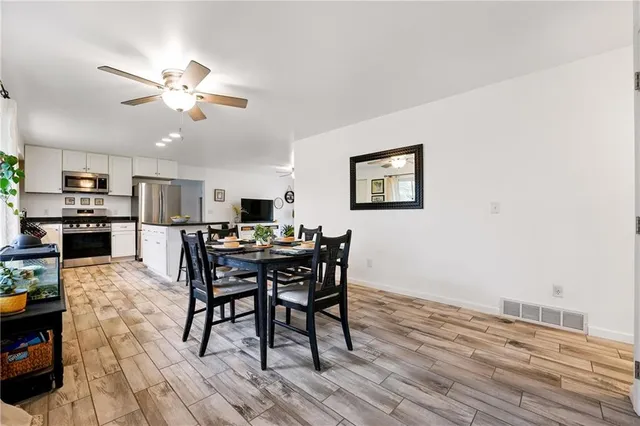 a view of a dining room with furniture and a kitchen
