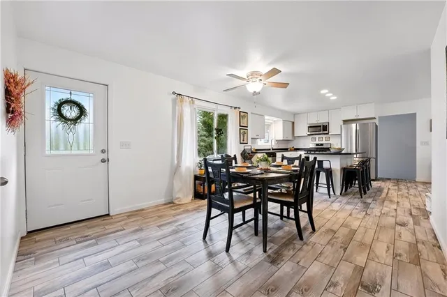 a view of a dining room with furniture and wooden floor