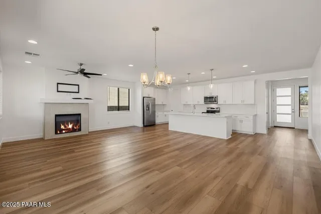 a view of a kitchen with granite countertop wooden floor and a fireplace