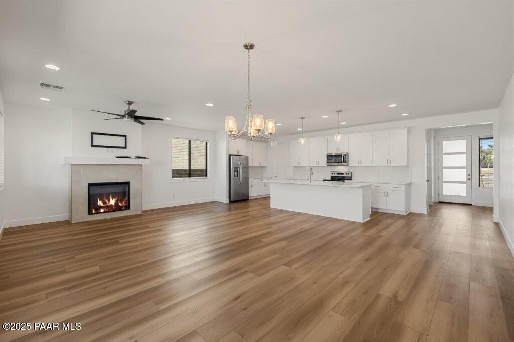 5008 Atwood Court Prescott Valley, AZ 86314 - Photo 12 of 34 a view of a kitchen with granite countertop wooden floor and a fireplace