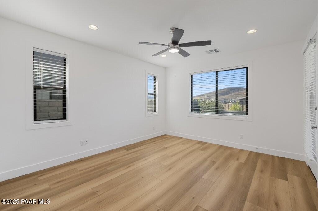 5008 Atwood Court Prescott Valley, AZ 86314 - Photo 15 of 34 a view of empty room with wooden floor and fan