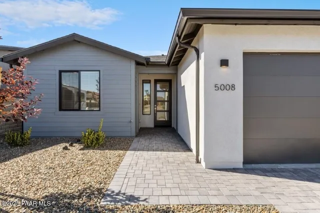 a view of a house with a small yard