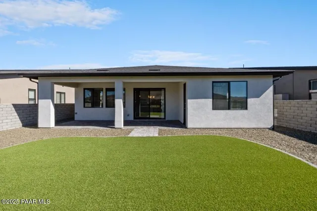 a view of a house with a backyard and porch