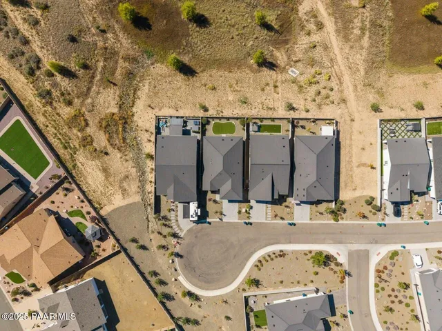 a view of a big house with a big yard and large tree