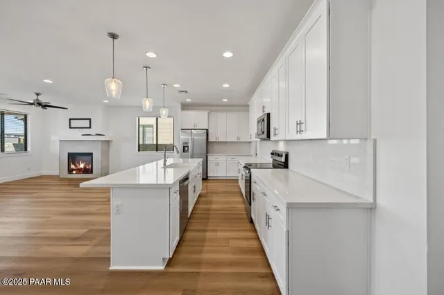 a large kitchen with cabinets a sink and dishwasher