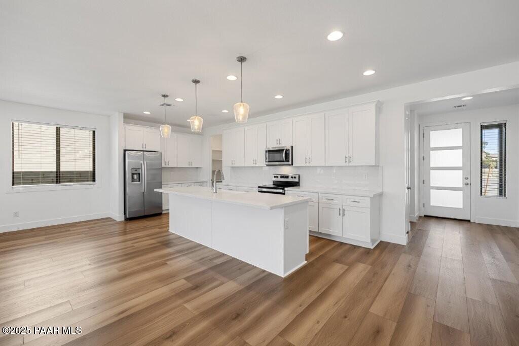 5008 Atwood Court Prescott Valley, AZ 86314 - Photo 5 of 34 a view of a kitchen with wooden floor and electronic appliances