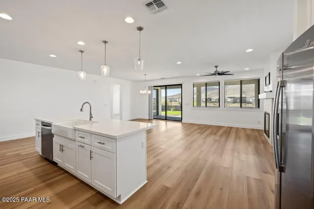 a view of a kitchen with a sink and wooden floor