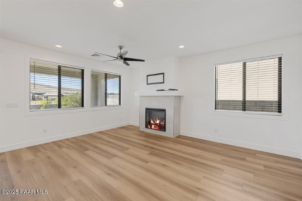 5008 Atwood Court Prescott Valley, AZ 86314 - Photo 9 of 34 a view of an empty room with a window and fireplace
