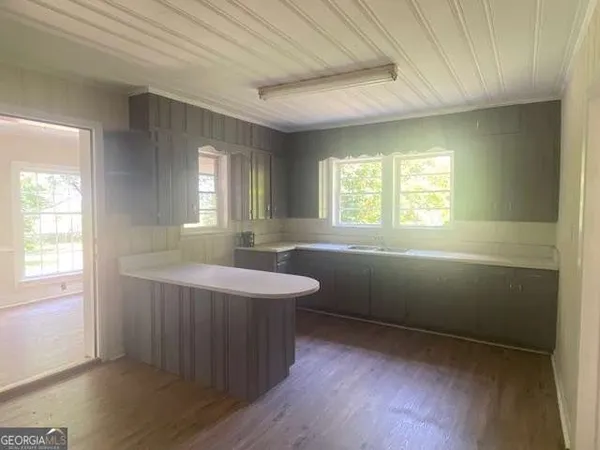 a room with wooden floors and window