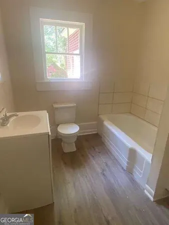 a bathroom with a sink a toilet and bathtub