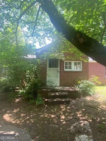 a view of a house with a tree