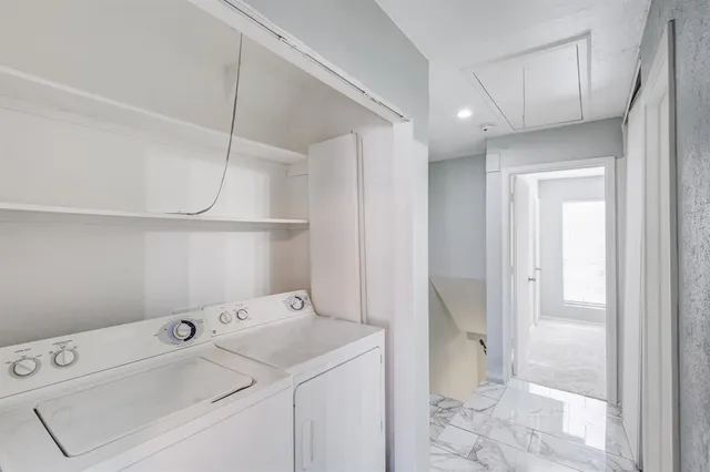 a view of storage and utility room with washer and dryer