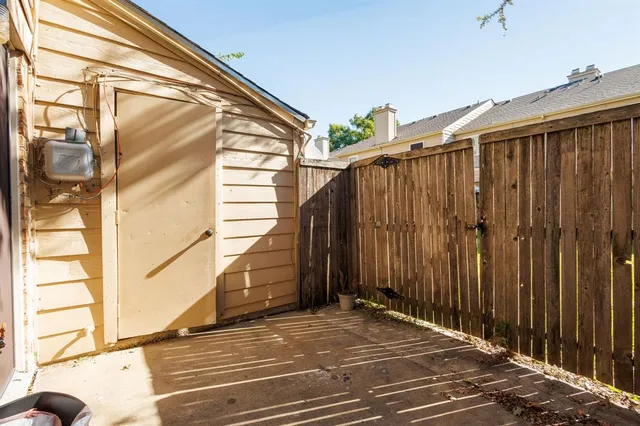 a view of a balcony with wooden fence and a window