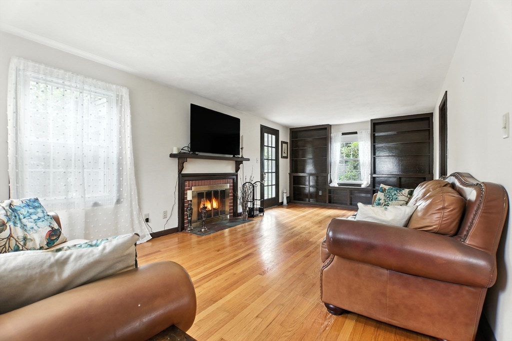 384 Abbott Street Springfield, MA 01118 - Photo 2 of 26 a living room with furniture a fireplace and a flat screen tv