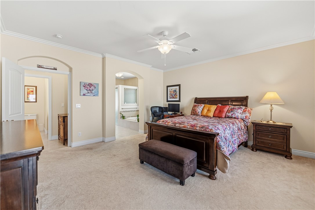 3315 Rainbow Mine Road Kingman, AZ 86401 - Photo 19 of 54 This carpeted bedroom features light-colored walls, crown molding, and a ceiling fan